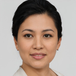 Joyful asian young-adult female with short  brown hair and brown eyes