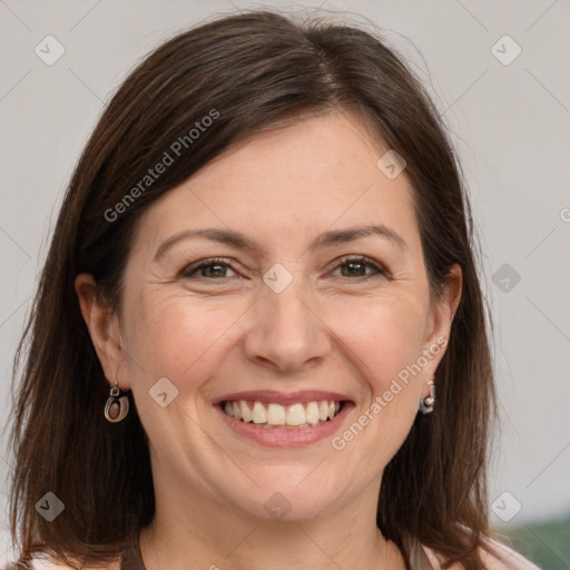 Joyful white adult female with long  brown hair and brown eyes