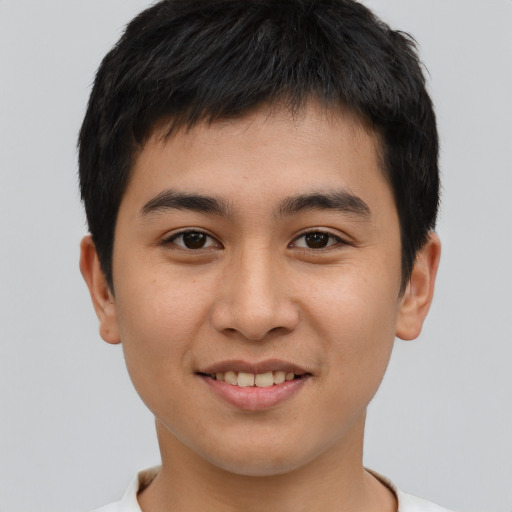 Joyful asian young-adult male with short  brown hair and brown eyes