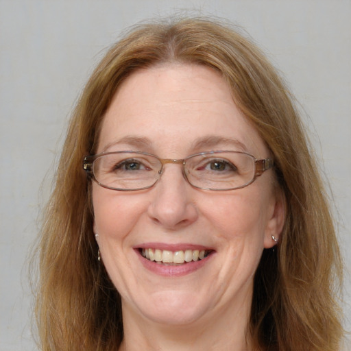 Joyful white adult female with long  brown hair and blue eyes