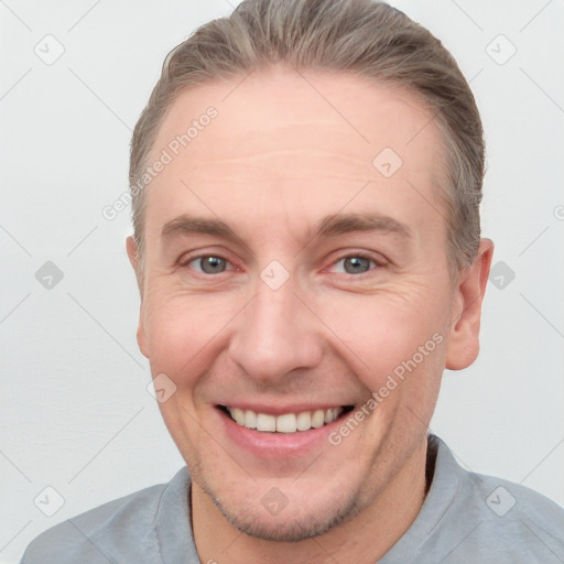 Joyful white adult male with short  brown hair and grey eyes