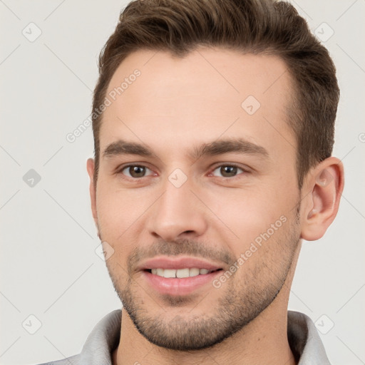 Joyful white young-adult male with short  brown hair and brown eyes