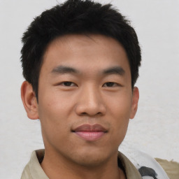 Joyful asian young-adult male with short  black hair and brown eyes