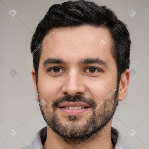 Joyful white young-adult male with short  black hair and brown eyes