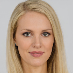 Joyful white young-adult female with long  brown hair and blue eyes