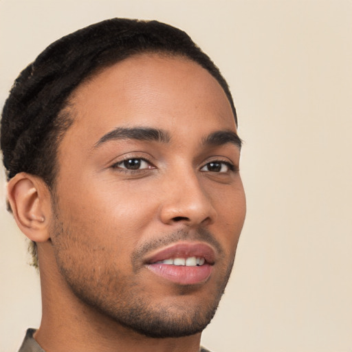 Joyful latino young-adult male with short  brown hair and brown eyes