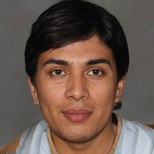 Joyful white young-adult male with short  black hair and brown eyes