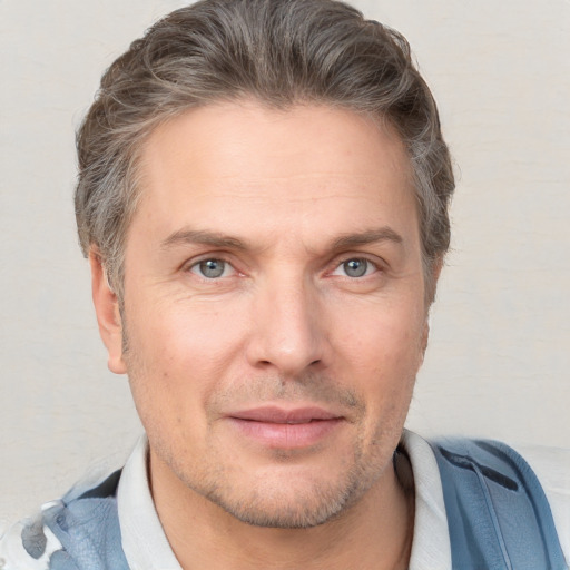 Joyful white adult male with short  brown hair and grey eyes