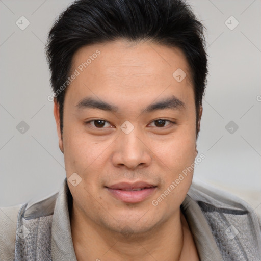 Joyful asian young-adult male with short  brown hair and brown eyes