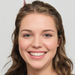Joyful white young-adult female with long  brown hair and blue eyes