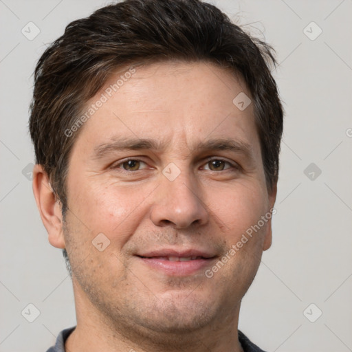 Joyful white adult male with short  brown hair and brown eyes