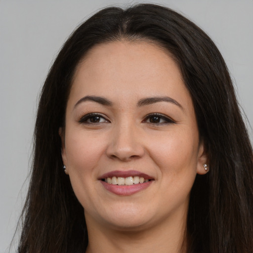 Joyful asian young-adult female with long  brown hair and brown eyes