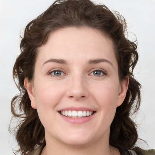 Joyful white young-adult female with medium  brown hair and green eyes