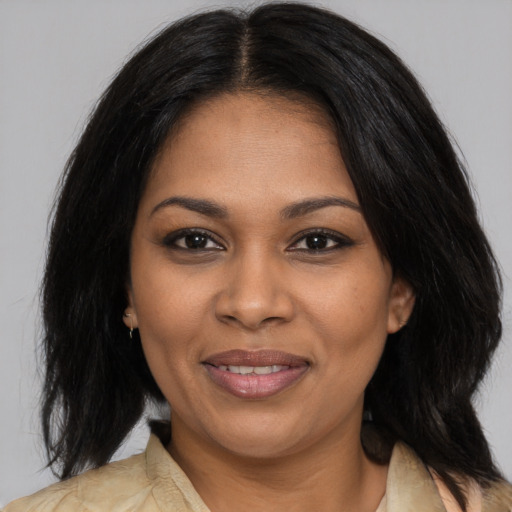 Joyful black young-adult female with medium  brown hair and brown eyes