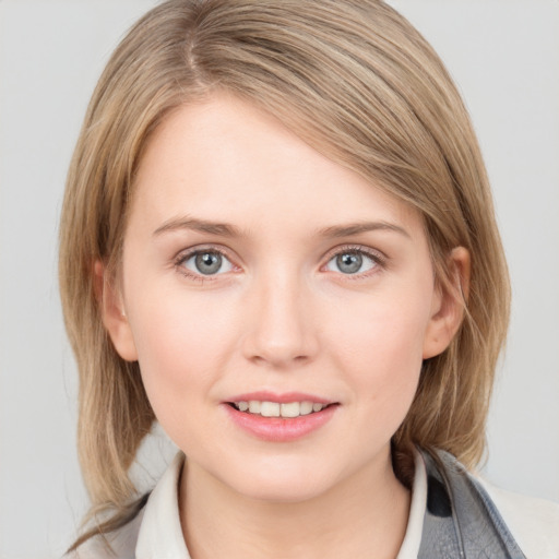 Joyful white young-adult female with medium  brown hair and blue eyes