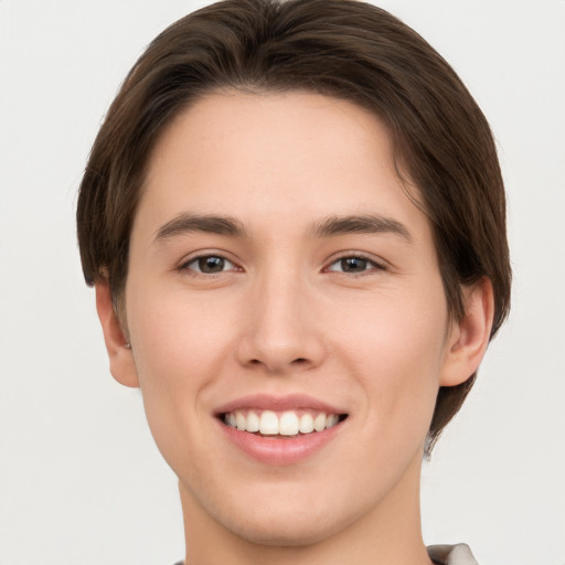 Joyful white young-adult female with short  brown hair and brown eyes