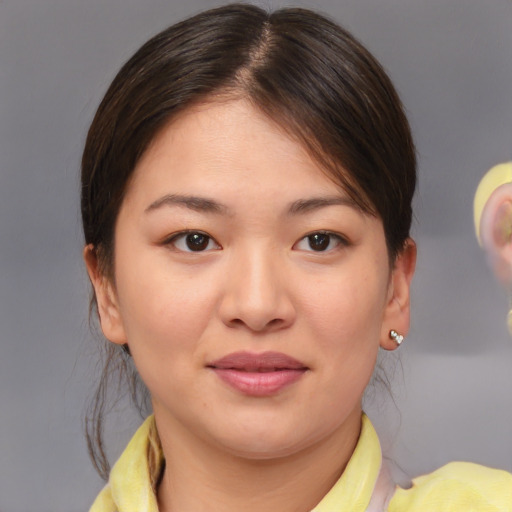 Joyful asian young-adult female with medium  brown hair and brown eyes