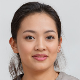 Joyful asian young-adult female with medium  brown hair and brown eyes