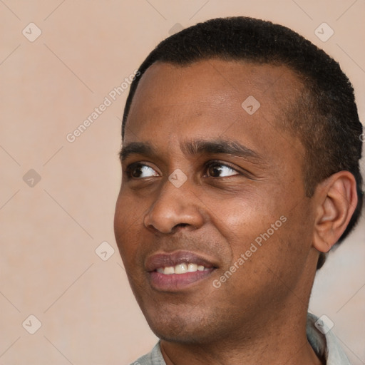 Joyful black young-adult male with short  black hair and brown eyes