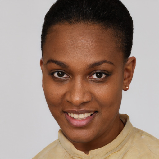 Joyful black young-adult female with short  black hair and brown eyes