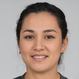 Joyful white young-adult female with medium  brown hair and brown eyes