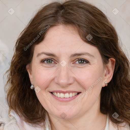 Joyful white adult female with medium  brown hair and grey eyes