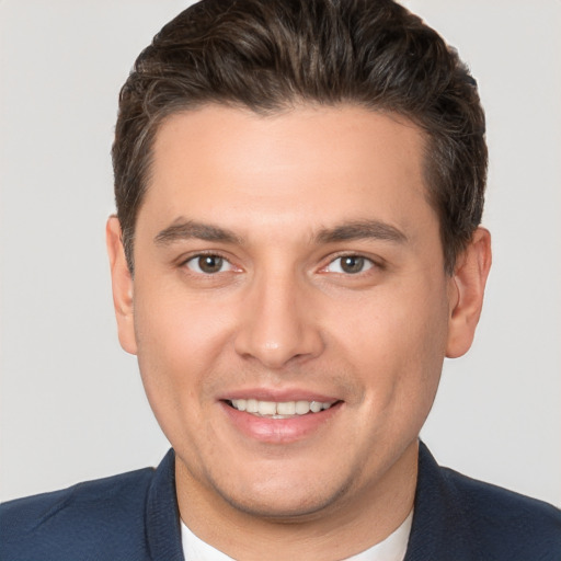 Joyful white young-adult male with short  brown hair and brown eyes