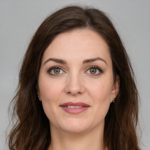 Joyful white young-adult female with medium  brown hair and green eyes