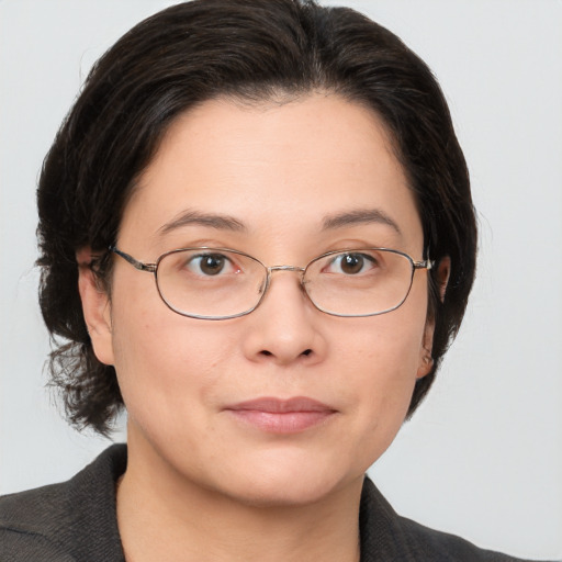 Joyful white adult female with medium  brown hair and brown eyes