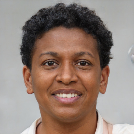 Joyful black adult female with short  brown hair and brown eyes