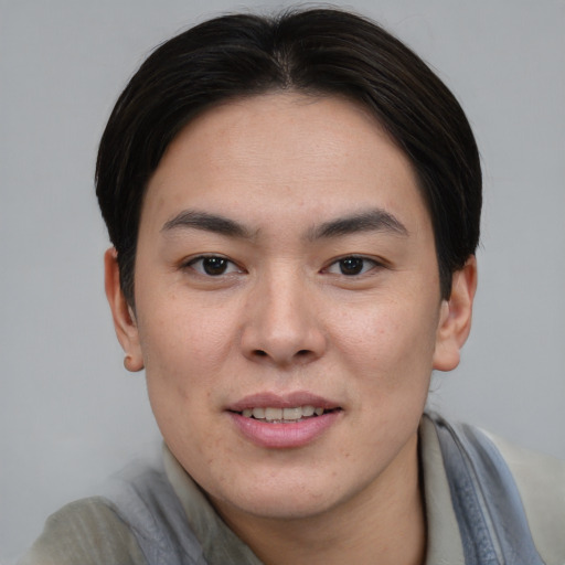 Joyful asian young-adult female with short  brown hair and brown eyes