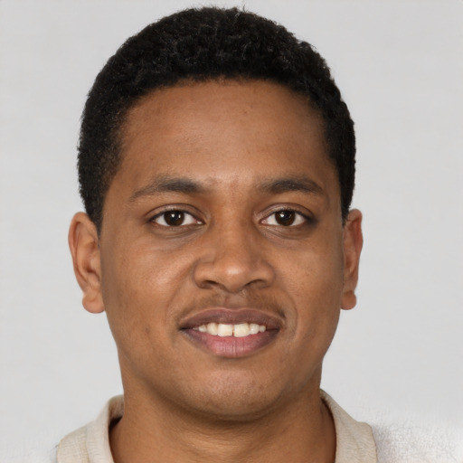 Joyful latino young-adult male with short  brown hair and brown eyes
