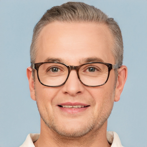 Joyful white adult male with short  brown hair and brown eyes