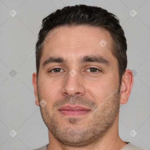 Joyful white young-adult male with short  brown hair and brown eyes