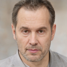 Joyful white middle-aged male with short  brown hair and brown eyes