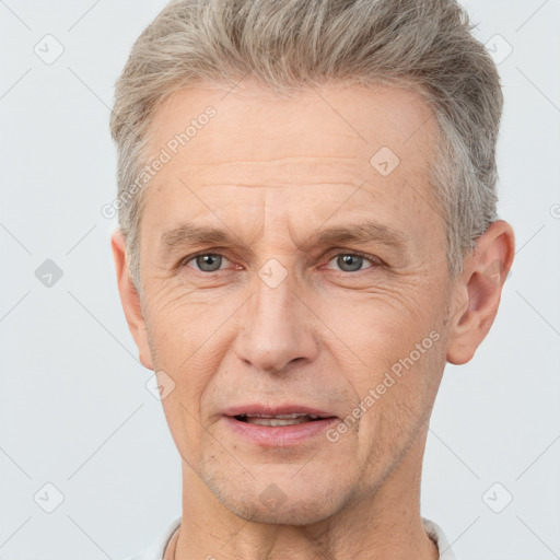 Joyful white middle-aged male with short  brown hair and brown eyes