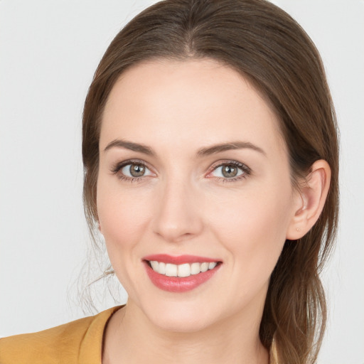 Joyful white young-adult female with long  brown hair and grey eyes