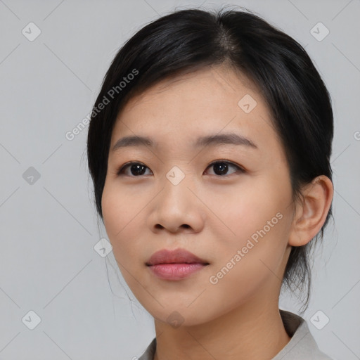 Joyful asian young-adult female with medium  black hair and brown eyes