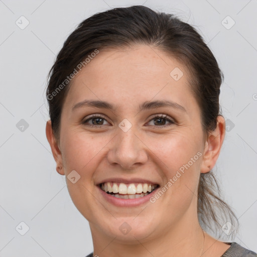 Joyful white young-adult female with medium  brown hair and grey eyes