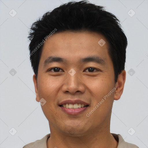 Joyful asian young-adult male with short  black hair and brown eyes