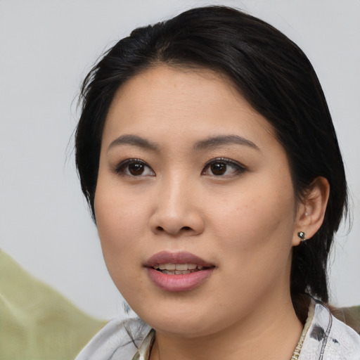 Joyful asian young-adult female with medium  black hair and brown eyes