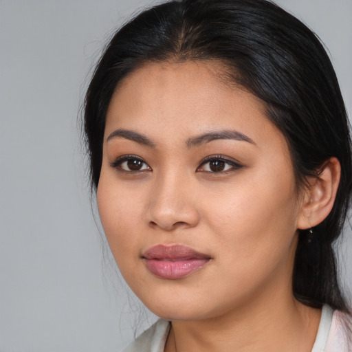 Joyful asian young-adult female with medium  brown hair and brown eyes