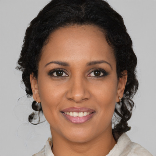Joyful black young-adult female with medium  black hair and brown eyes