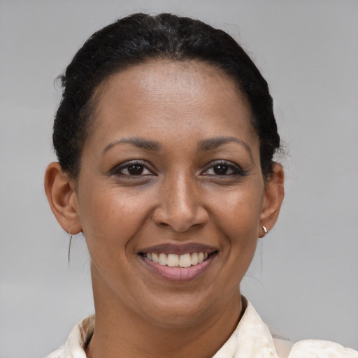 Joyful black adult female with short  brown hair and brown eyes