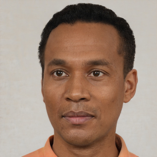 Joyful black young-adult male with short  black hair and brown eyes