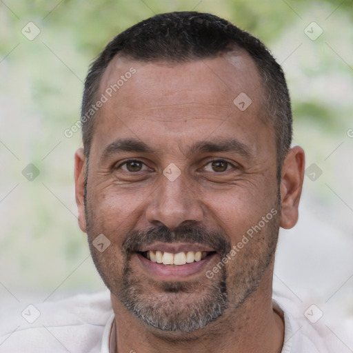 Joyful white adult male with short  black hair and brown eyes