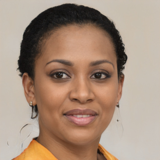 Joyful black young-adult female with medium  brown hair and brown eyes