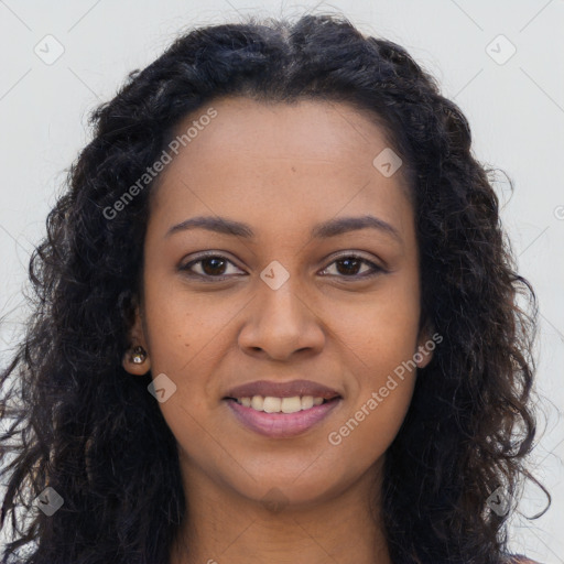 Joyful black young-adult female with long  brown hair and brown eyes