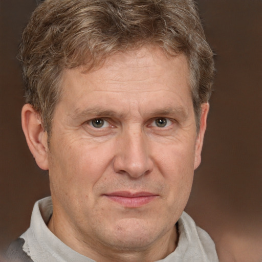 Joyful white middle-aged male with short  brown hair and brown eyes