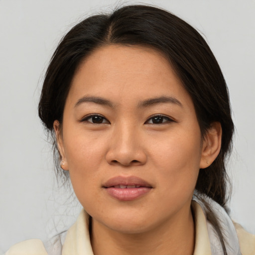 Joyful asian young-adult female with medium  brown hair and brown eyes
